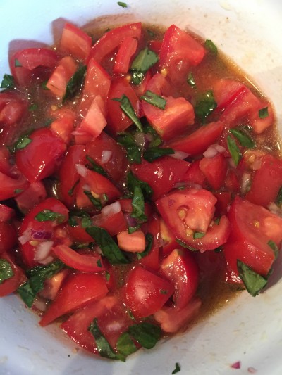 The salt draws juices out of the tomatoes, and the oil/juice mix will eventually cover the tomatoes if you leave them long enough. 