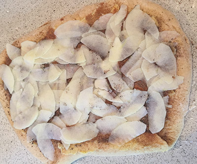 Very fine slices of apple layered over the top of the spices.