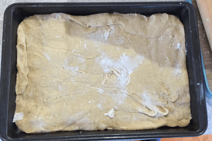 Spread the dough out on a tray.